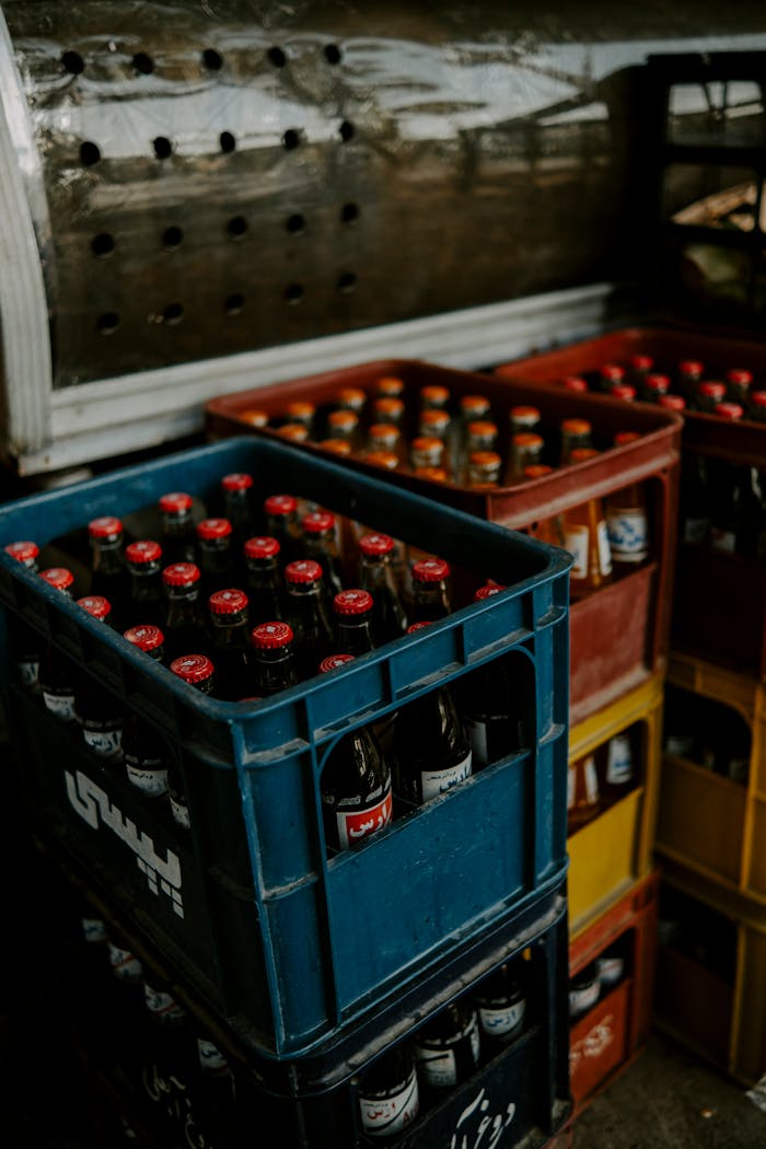 Vertical shot of colorful crates filled with bottled drinks, ideal for beverage industry concepts.